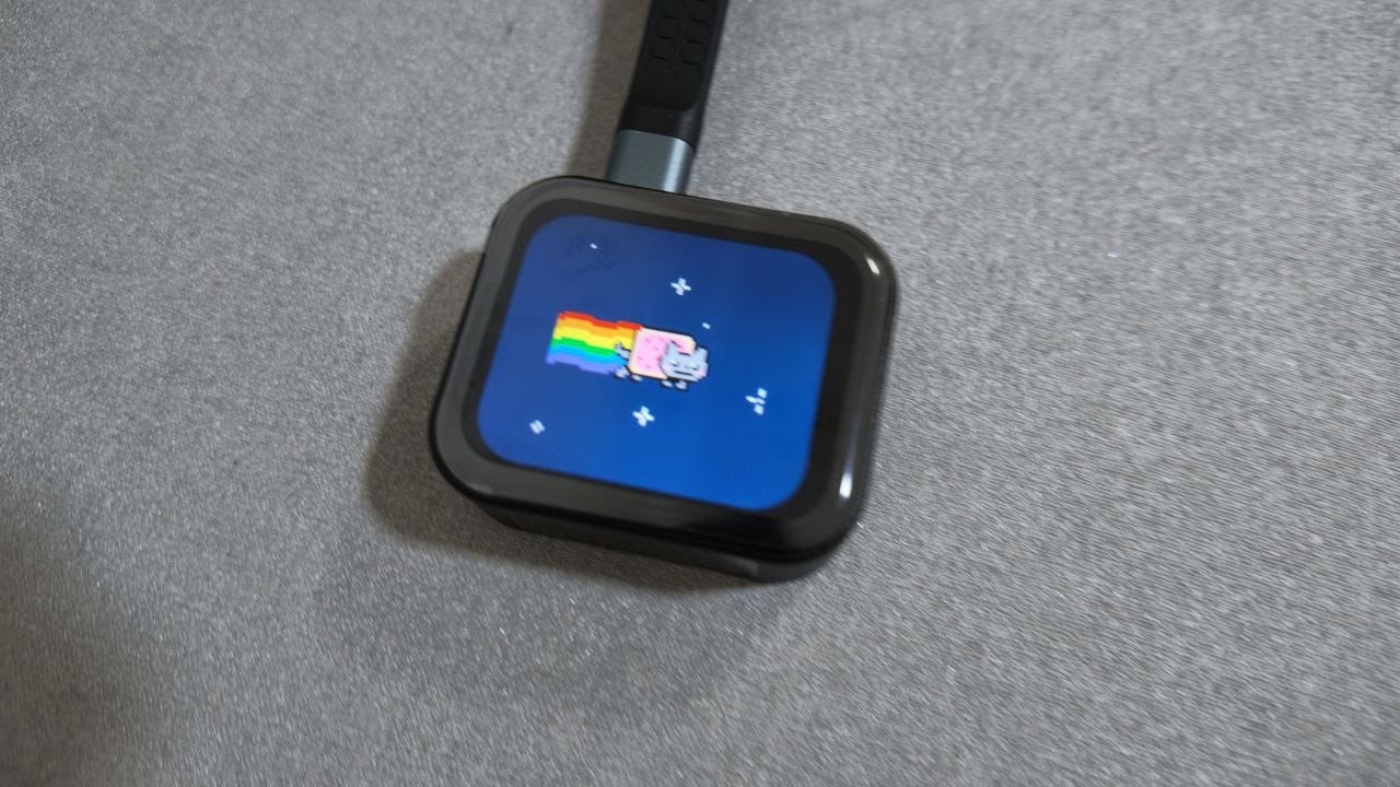 NanoKVM Go powered on, its 1.83-inch colour touchscreen showing a Nyan Cat animation